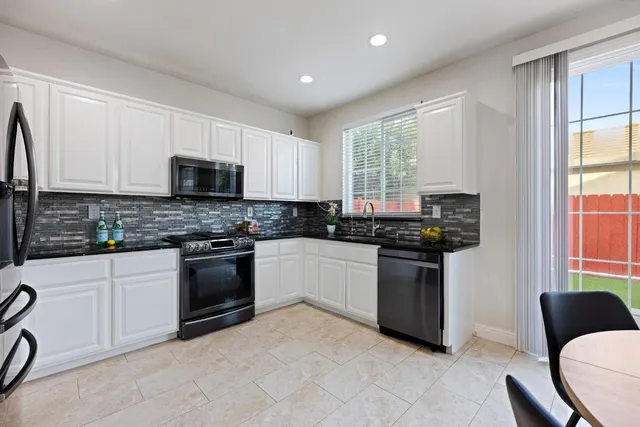 a kitchen with a window a sink and a stove