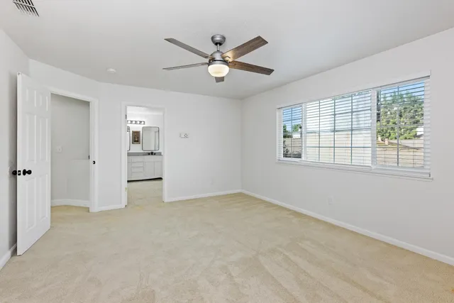 a bathroom with a granite countertop bathtub shower and toilet