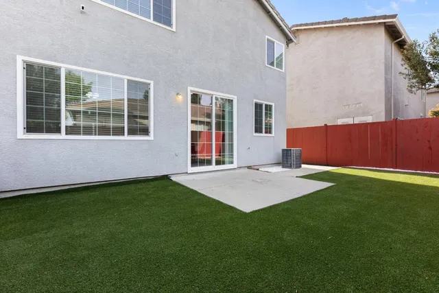 an aerial view of residential house with outdoor space and swimming pool