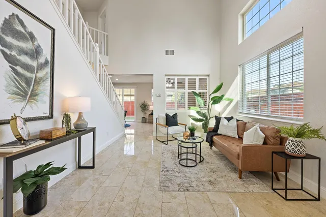 a living room with furniture and a potted plant