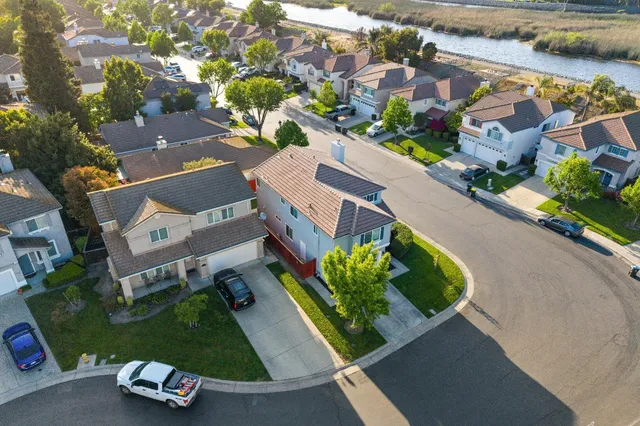 an aerial view of a house with a yard basket ball court and outdoor seating