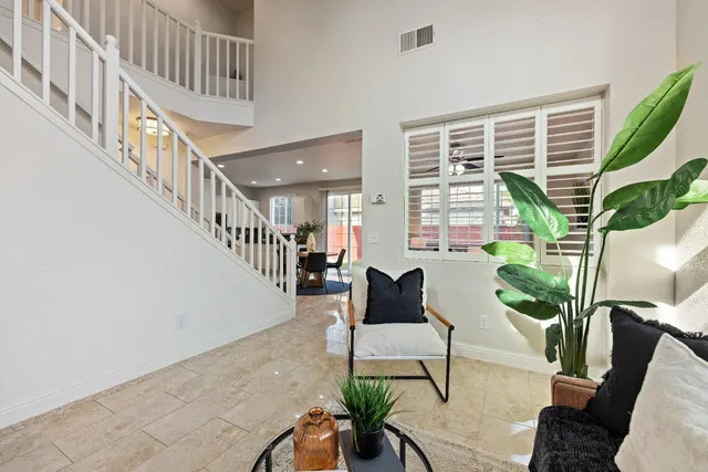 a porch with furniture and a potted plant