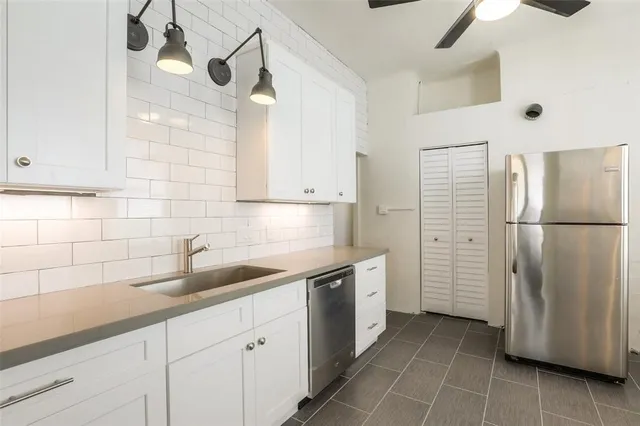 a kitchen with a refrigerator and cabinets