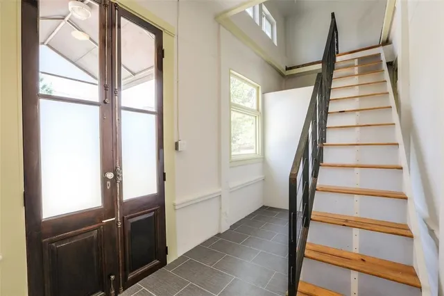 a view of staircase with white walls and windows