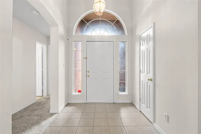 an empty room with a mirror and a fan