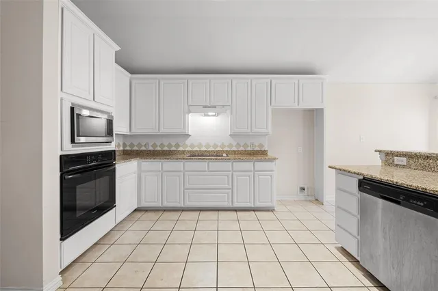 a kitchen with a stove a sink and a refrigerator