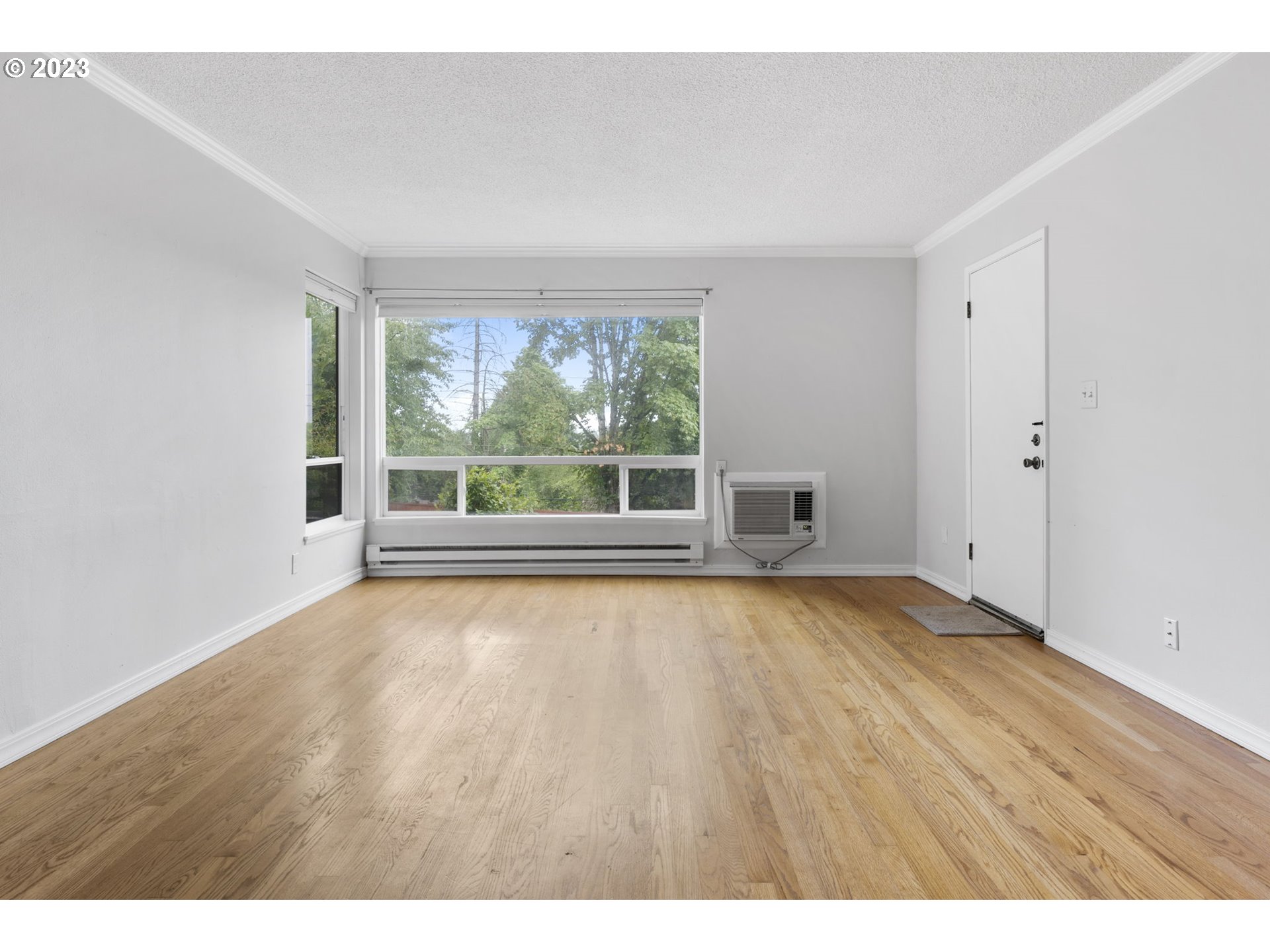 8400 Southwest Canyon Lane, Unit 6 Portland, OR 97225 - Photo 6 of 19 a view of an empty room with wooden floor and a window