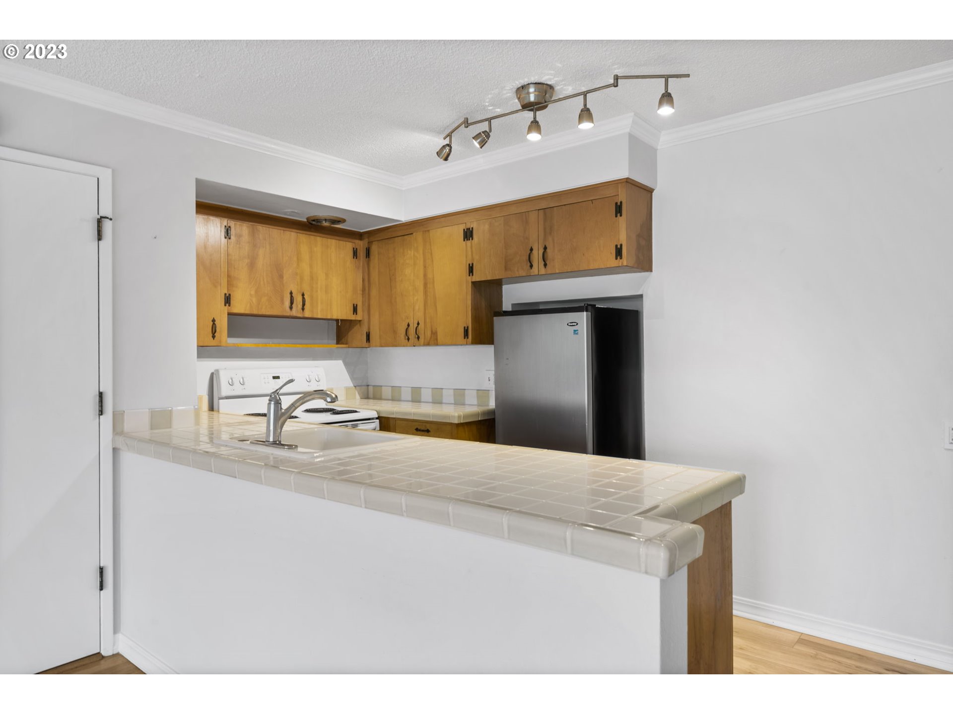 8400 Southwest Canyon Lane, Unit 6 Portland, OR 97225 - Photo 9 of 19 a kitchen with a sink a stove and refrigerator