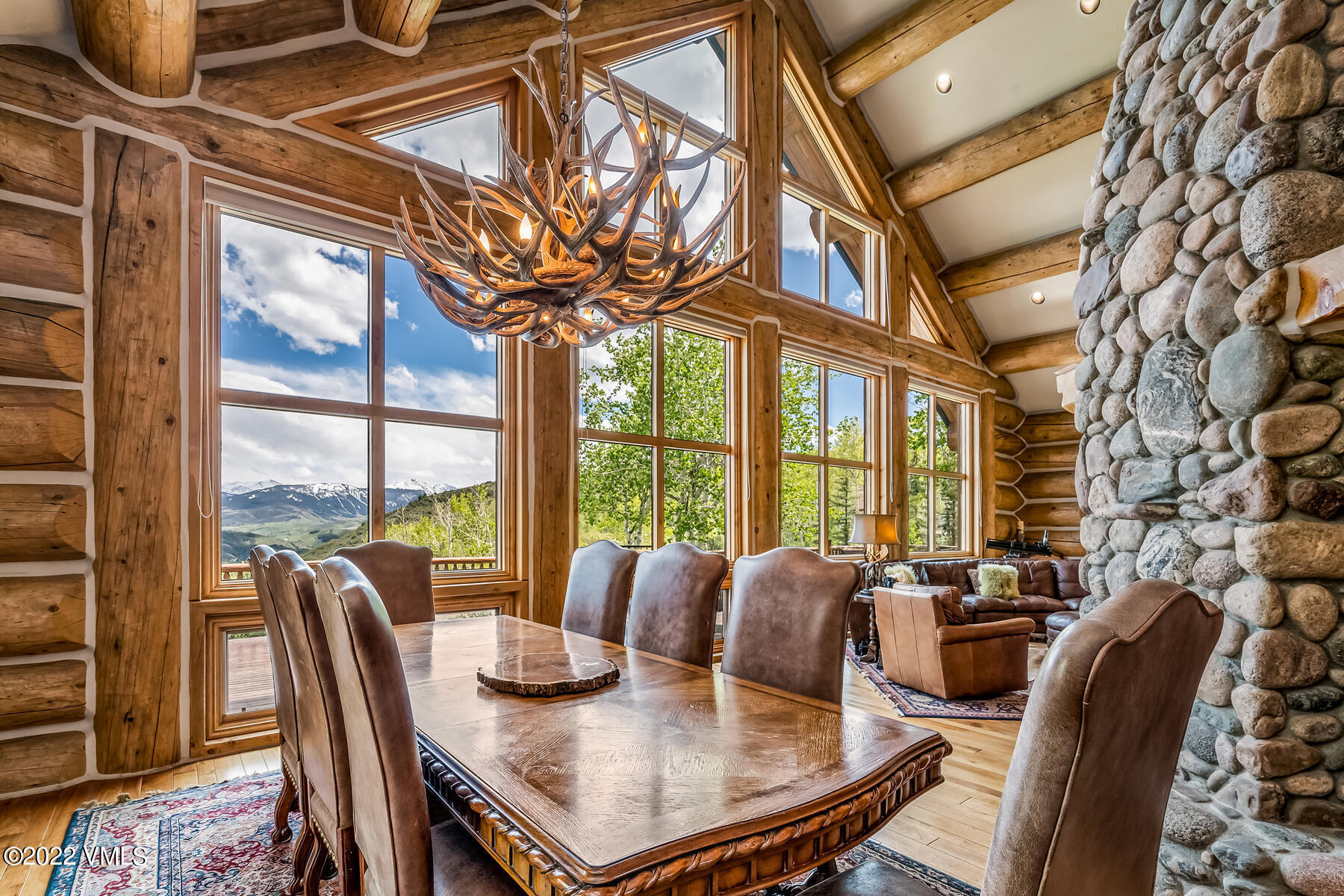 4000 Bellyache Ridge Road Wolcott, CO 81655 - Photo 19 of 56 a view of a dining room with furniture a chandelier and wooden floor