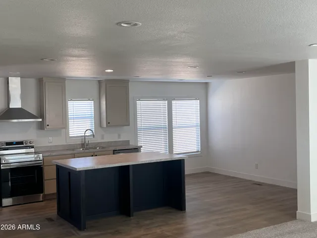 a kitchen with a sink stove and cabinets