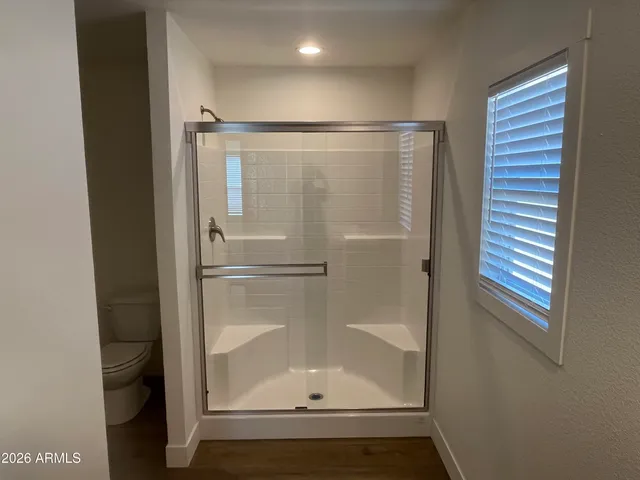 a bathroom with a toilet and a shower