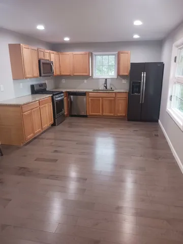 a large kitchen with lots of counter space and stainless steel appliances