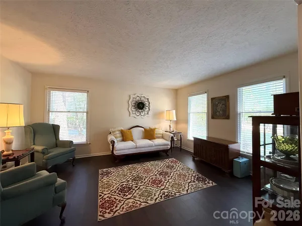 a view of a dining room with furniture wooden floor and a chandelier