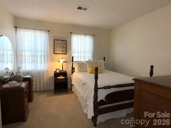 a bed room with a bed window and a table