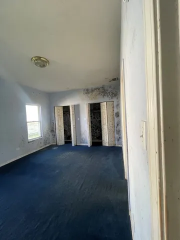 a view of a livingroom with an empty space and a window