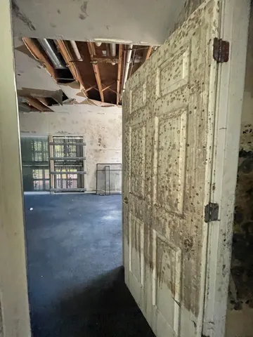 a view of a hallway with wooden walls