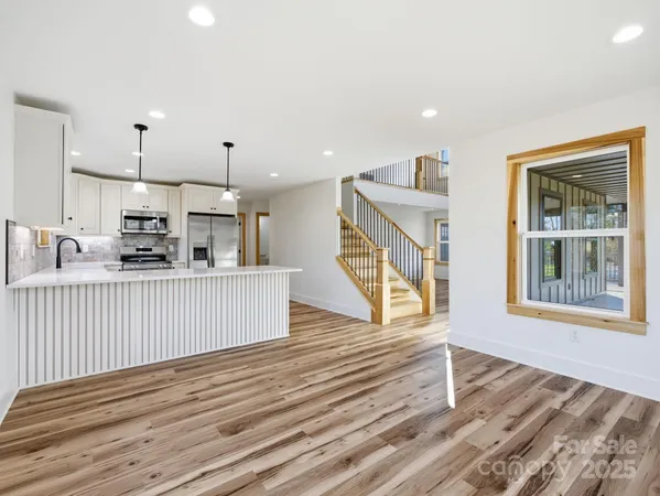 a view of kitchen with furniture wooden floor and windows