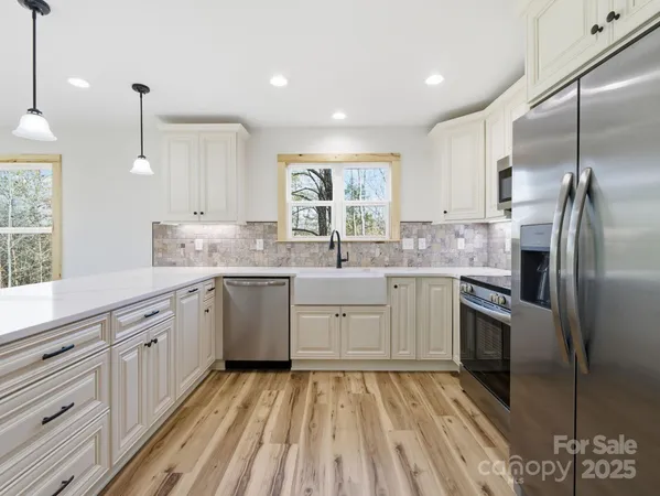 a kitchen with a sink stove and refrigerator