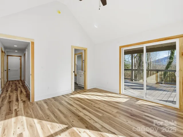 a view of a livingroom with wooden floor and front door