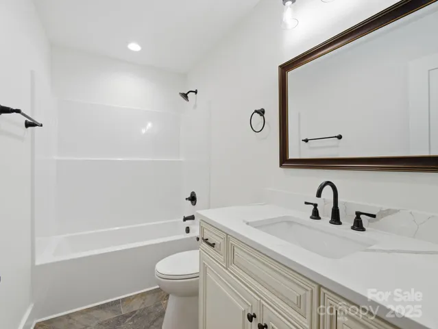 an empty room with a window and a ceiling fan