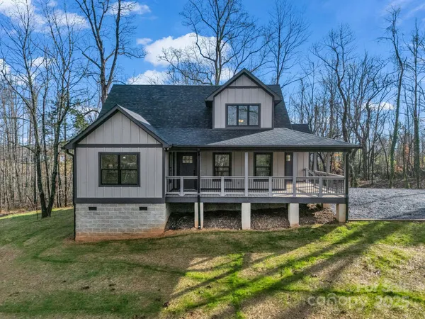 a view of house with a yard