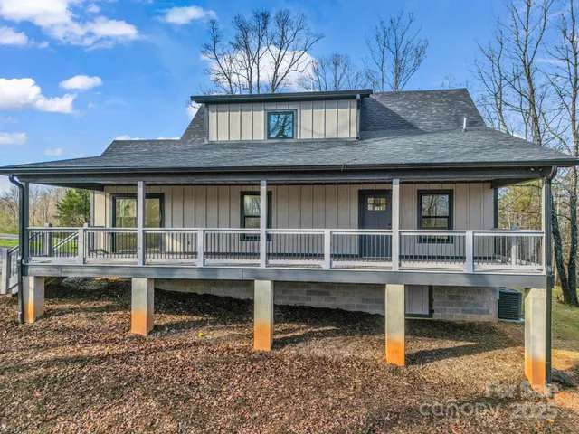 a view of a house with a window and wooden fence