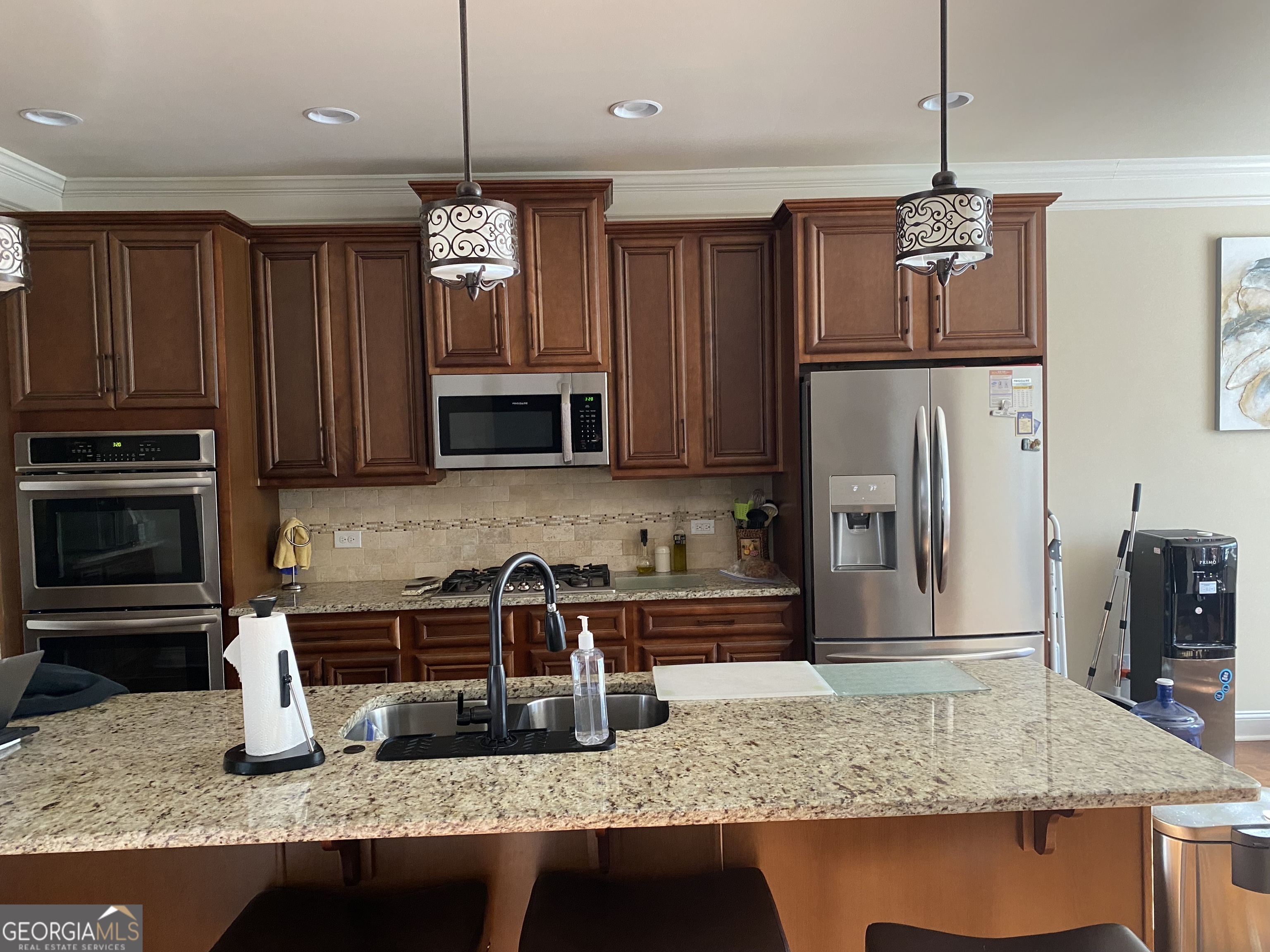 156 Elkins Boulevard Locust Grove, GA 30248 - Photo 15 of 36 a kitchen with stainless steel appliances granite countertop a sink refrigerator and microwave