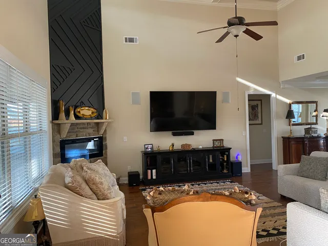 a living room with furniture and a flat screen tv