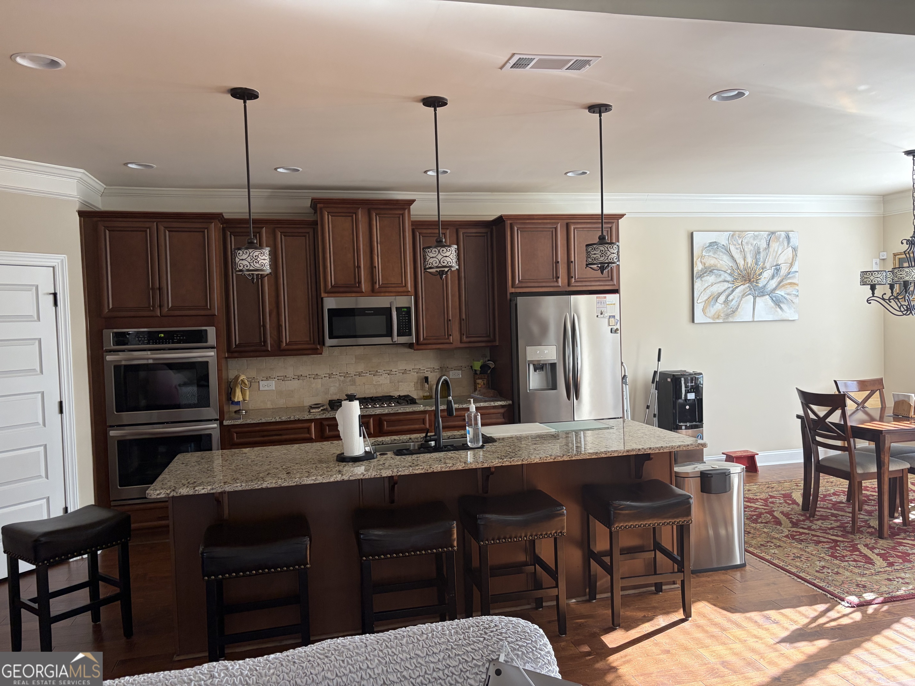 156 Elkins Boulevard Locust Grove, GA 30248 - Photo 29 of 36 a kitchen with a refrigerator a stove a sink and chairs