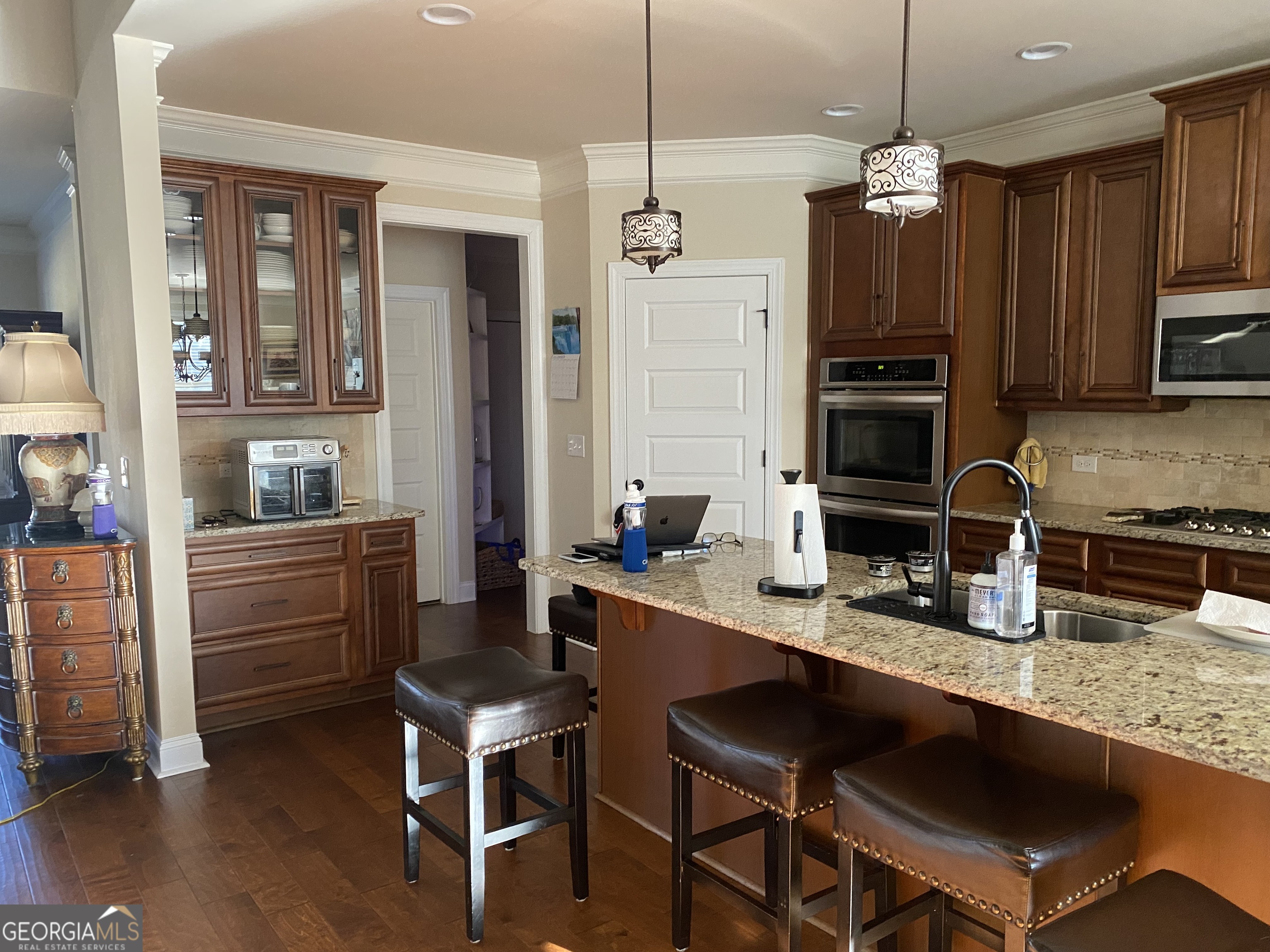 156 Elkins Boulevard Locust Grove, GA 30248 - Photo 3 of 36 a kitchen with granite countertop a stove a sink and a refrigerator