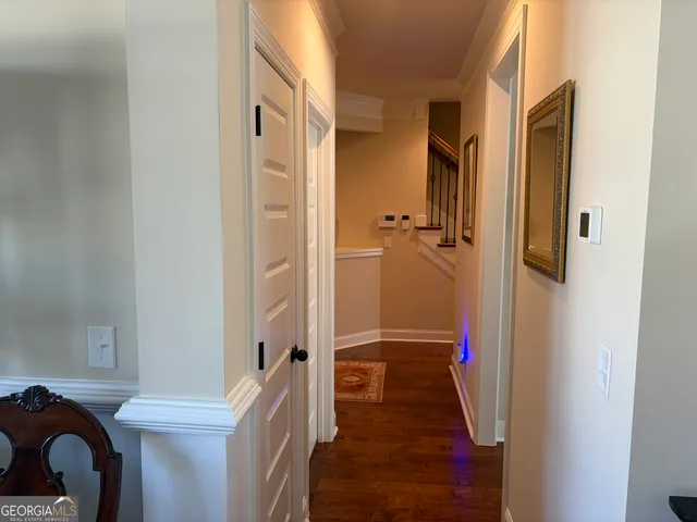 a living room with furniture and a view of kitchen