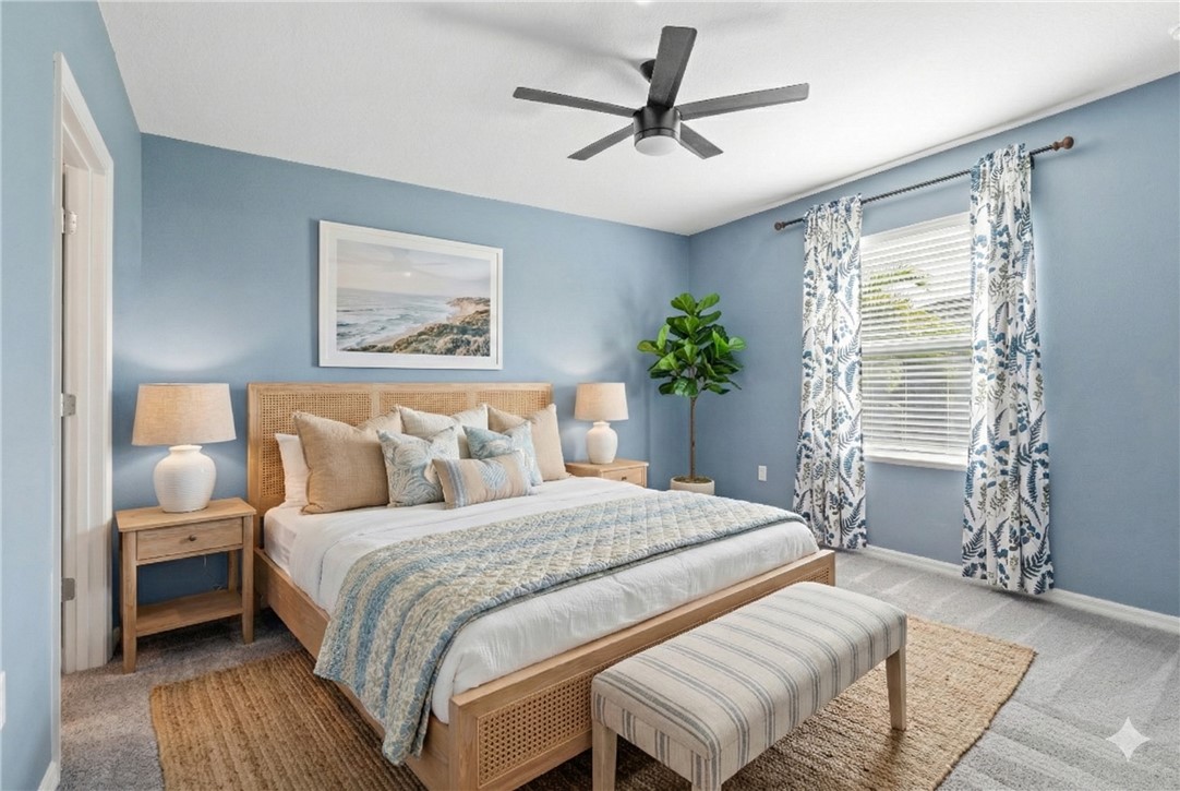 6045 Red Maple Manor Vero Beach, FL 32966 - Photo 14 of 36 a bedroom with a large bed and a chandelier