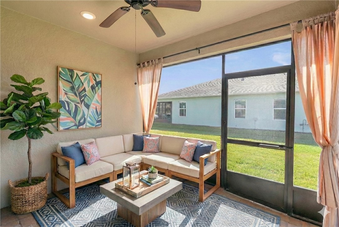 6045 Red Maple Manor Vero Beach, FL 32966 - Photo 23 of 36 a living room with furniture and a large window