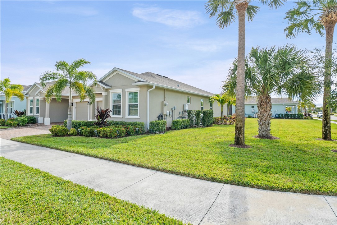6045 Red Maple Manor Vero Beach, FL 32966 - Photo 26 of 36 a front view of house with yard and green space