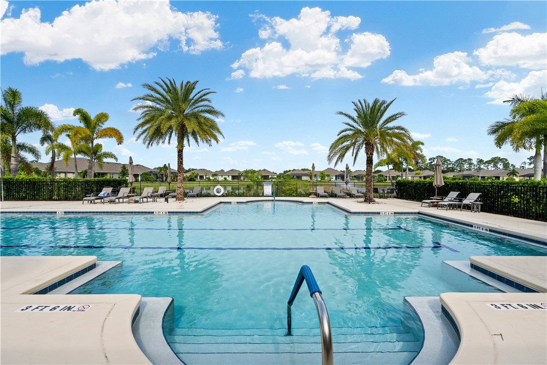 6045 Red Maple Manor Vero Beach, FL 32966 - Photo 28 of 36 a view of a swimming pool with a table and chairs