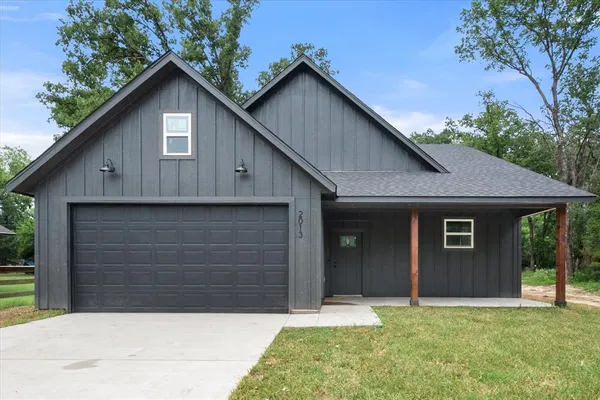 a front view of a house with a yard and garage