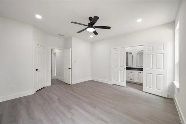 a view of empty room with wooden floor and window
