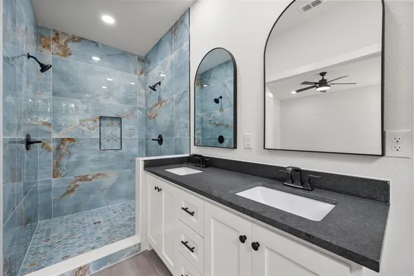 a bathroom with a granite countertop sink mirror and double