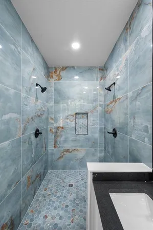 a bathroom with a shower and a sink