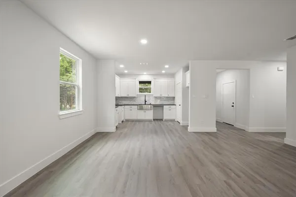 a view of kitchen with wooden floor electronic appliances and window