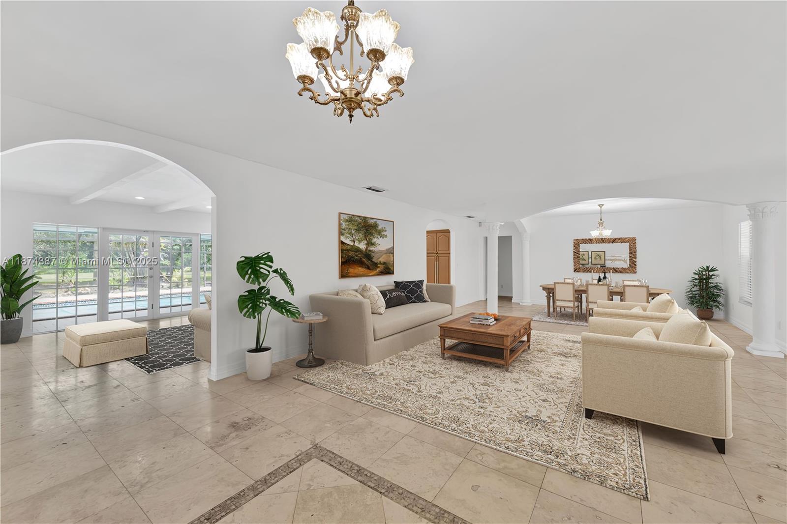 14780 Old Cutler Road, Unit 14780 Palmetto Bay, FL 33158 - Photo 1 of 16 a living room with fireplace furniture and a chandelier