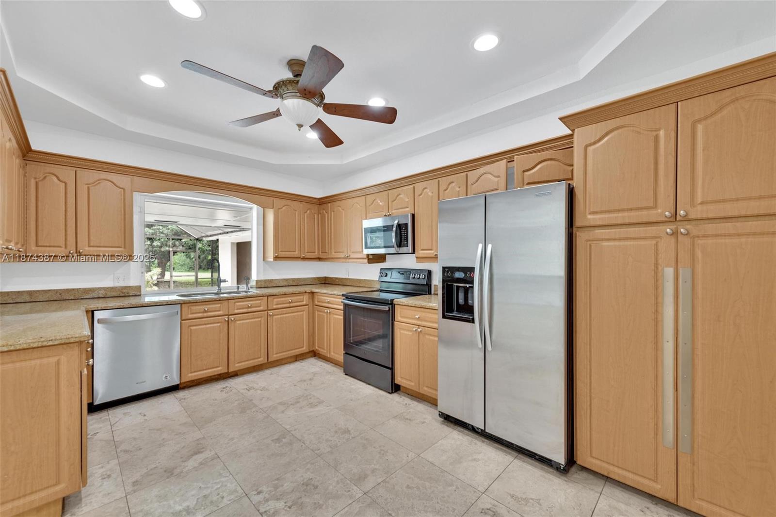 14780 Old Cutler Road, Unit 14780 Palmetto Bay, FL 33158 - Photo 11 of 16 a kitchen with granite countertop stainless steel appliances a refrigerator cabinets and a sink