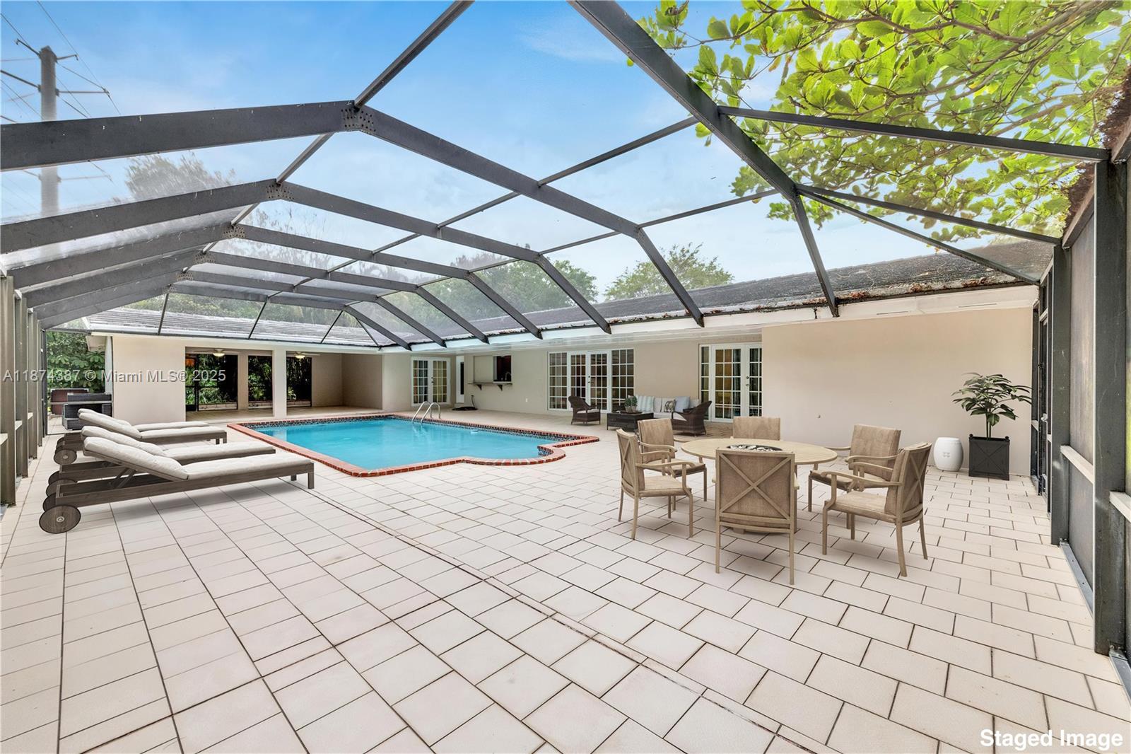 14780 Old Cutler Road, Unit 14780 Palmetto Bay, FL 33158 - Photo 13 of 16 a view of a patio with table and chairs and wooden floor