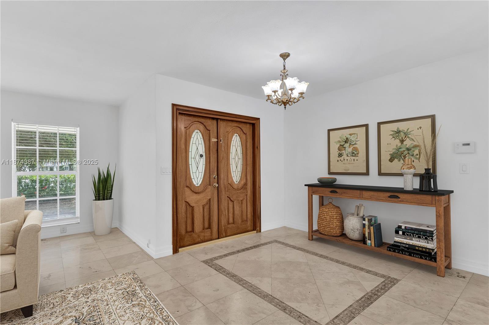 14780 Old Cutler Road, Unit 14780 Palmetto Bay, FL 33158 - Photo 4 of 16 a view of a livingroom with furniture and chandelier wooden floor