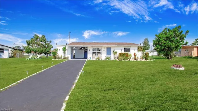 a front view of a house with garden