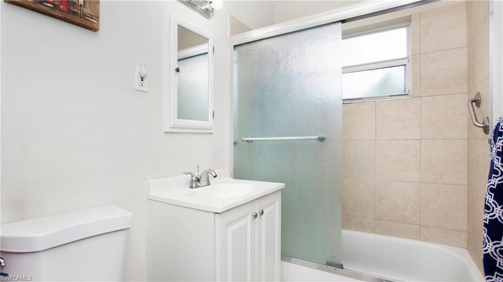 515 York Road Lehigh Acres, FL 33936 - Photo 14 of 22 a bathroom with a sink toilet and shower