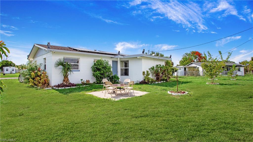515 York Road Lehigh Acres, FL 33936 - Photo 20 of 22 a front view of a house with garden