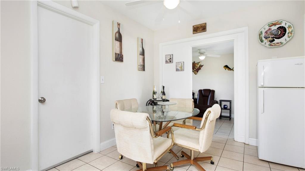 515 York Road Lehigh Acres, FL 33936 - Photo 9 of 22 a dining room with furniture and wooden floor