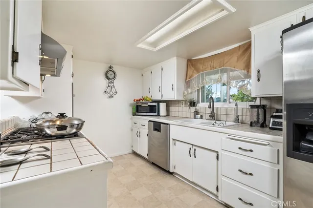 a kitchen with a sink stove and cabinets