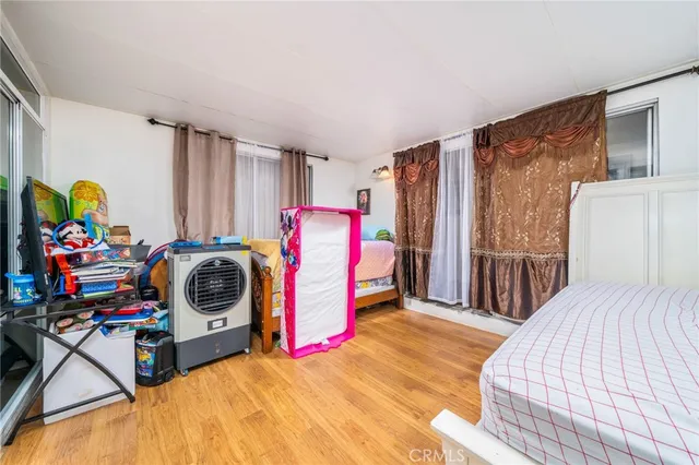 a view of a bedroom with a bed and toys